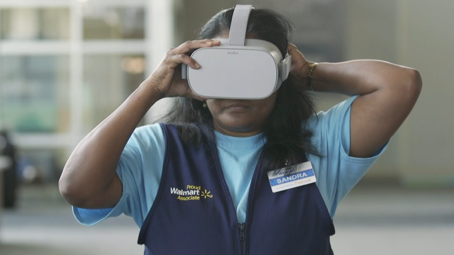 Associate Sandra puts on an Oculus VR Headset