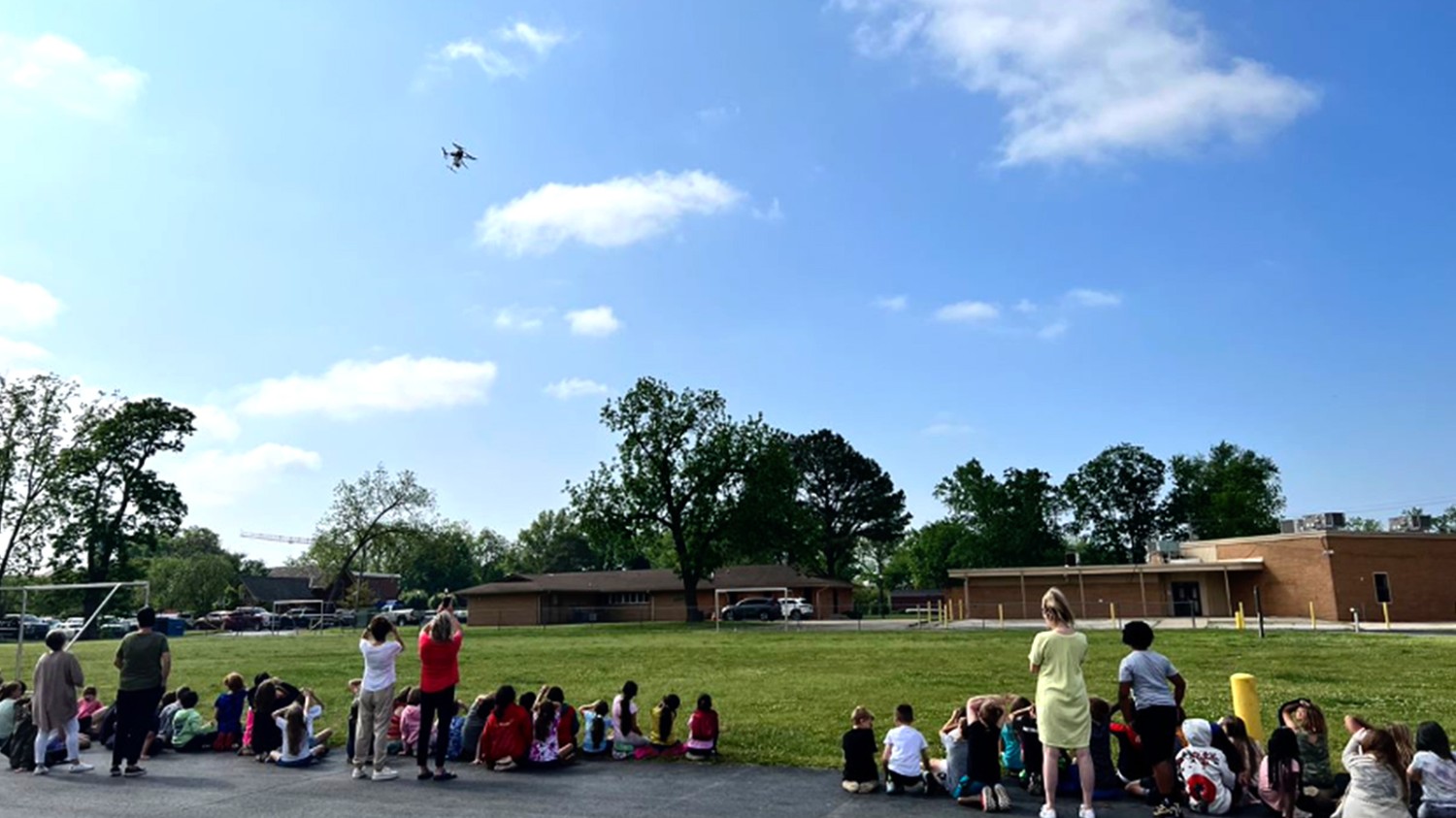 Students at R.E. Baker Elementary in Bentonville, AR cheer as a drone delivers gift cards and goodies to teachers for Teacher Appreciation Week.