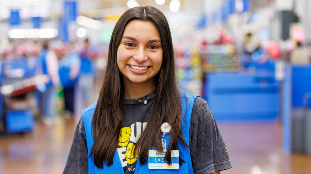 An associate in store smiles at the camera.