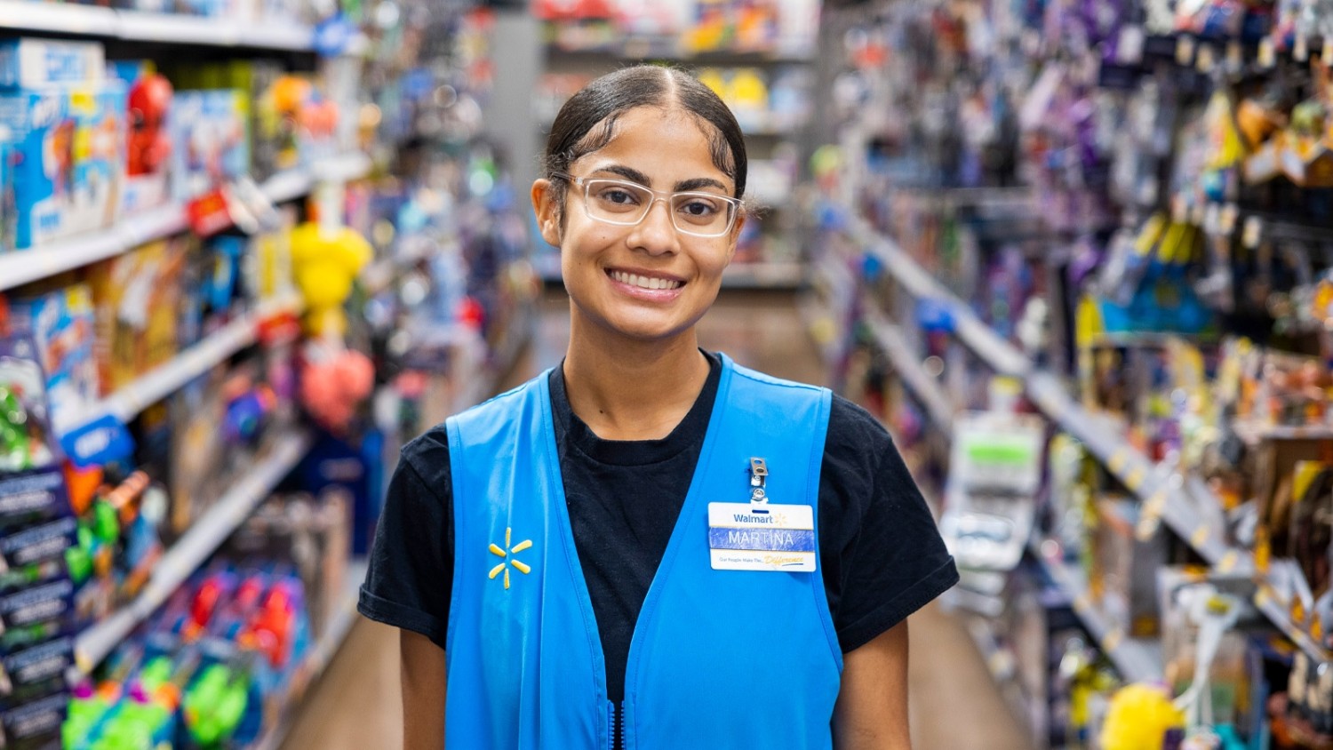 Walmart associate Martina stands in the toy section of her store.