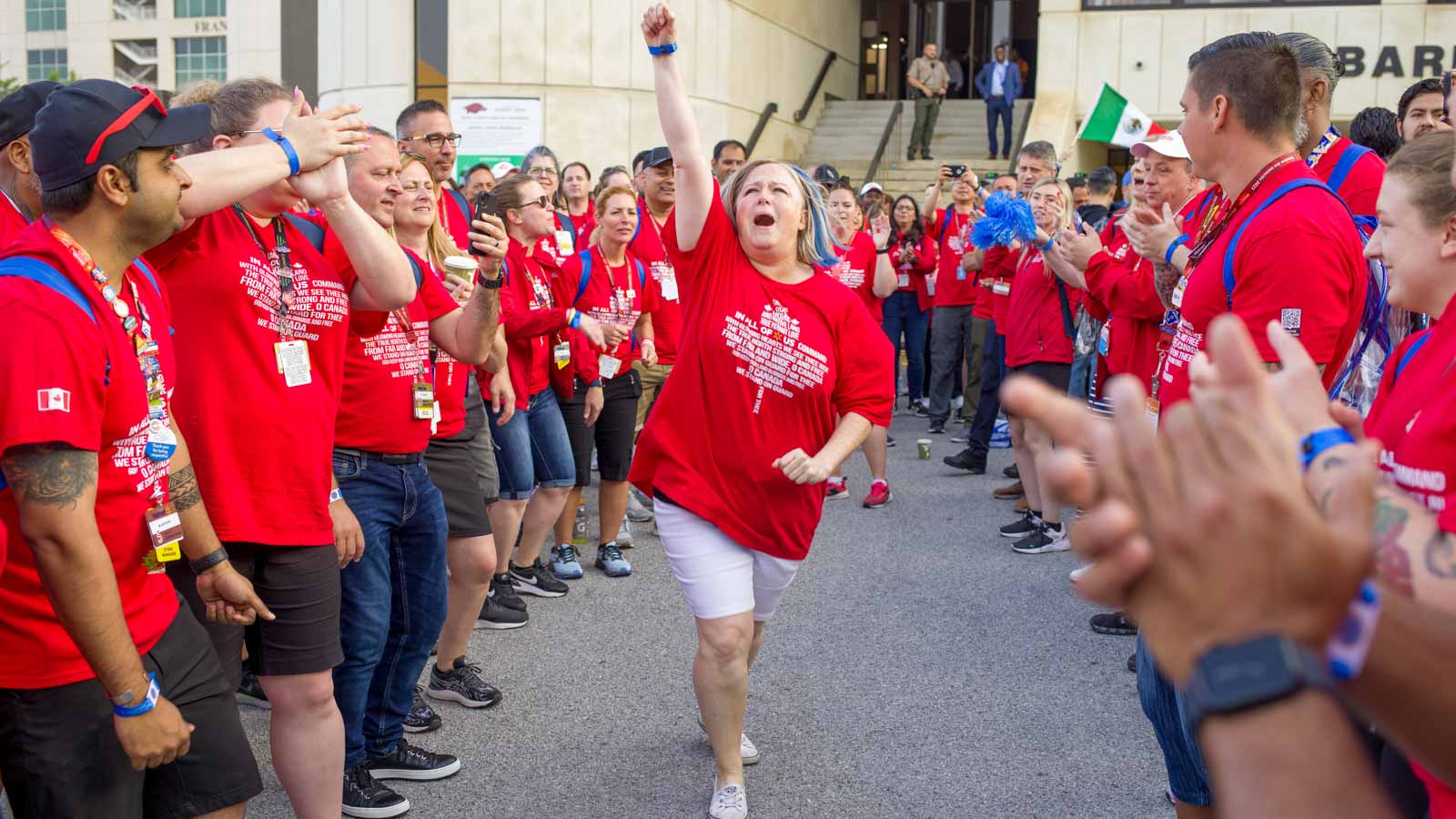 Canadian associates cheer while arriving to Associate's Week activities.