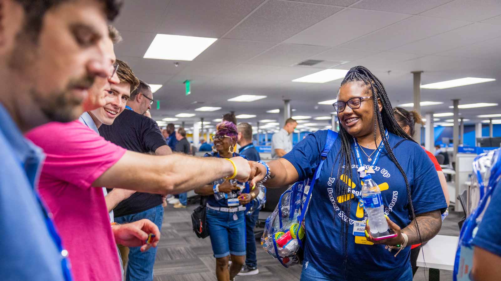 Associates visiting the Walmart Home Office in Bentonville, Ark., are greeted by home office associates, high fives and swag.