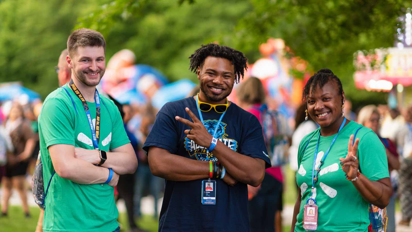 Three Walmart associates pose for a picture outside at a celebration.