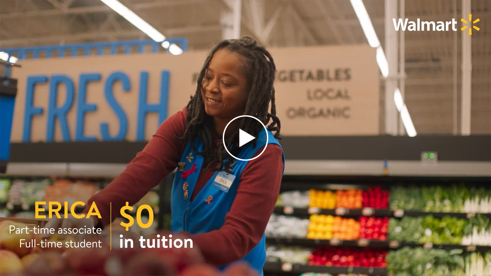 Screen capture with play icon from video. Capture shows associate stocking grocery. Text on screen reads Erica part-time associate full-time student. $0 in tuition.